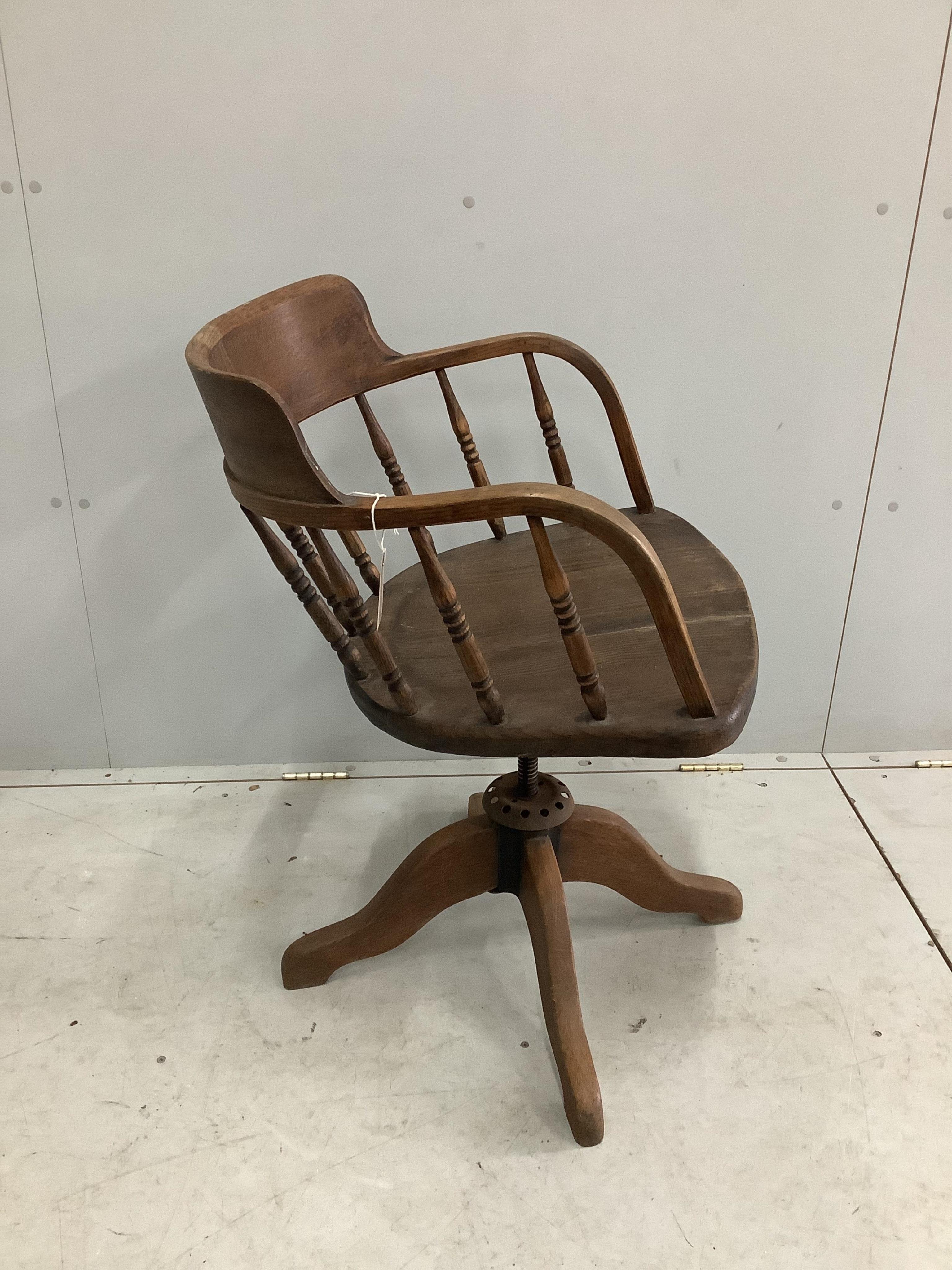 An early 20th century oak swivel desk chair, width 54cm, depth 46cm, height 85cm. Condition - poor